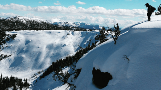 person on top of snowy cliff